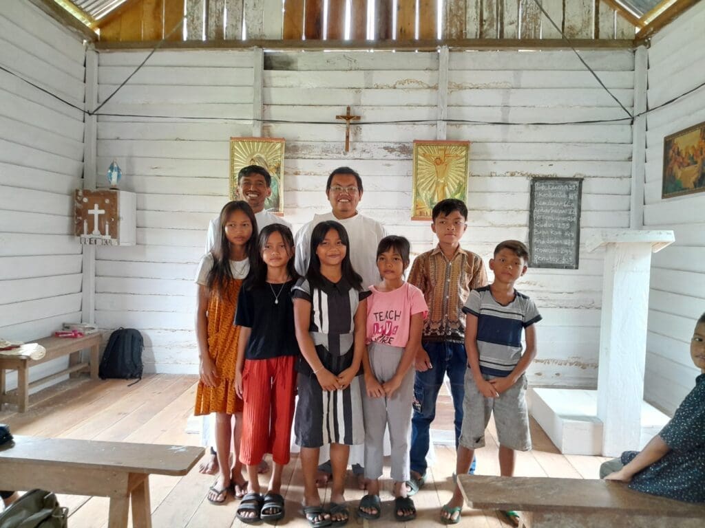 Father Novan and children at the station church